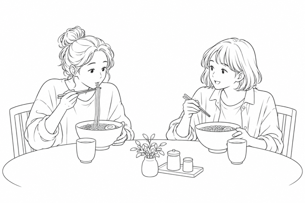 One diner draws noodles toward their mouth while a friend looks up